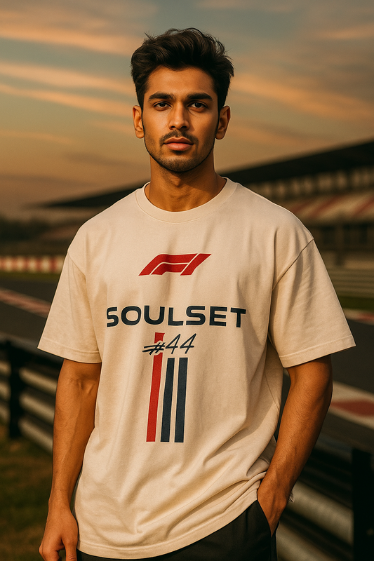 Men wearing oversized beige F1-inspired SoulSet t-shirt with #44 graphic at a racetrack – stylish motorsport streetwear by SoulSet.Store