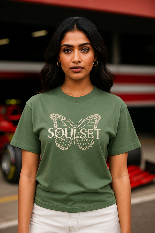 Confident young Indian female model wearing an oversized forest green t-shirt with a ‘KAIZEN’ themed back design featuring a butterfly and evolution graphics. The model stands stylishly in a relaxed pose, showcasing the t-shirt’s fit and artwork against a sleek, minimalist backdrop. Ideal for fashion e-commerce, streetwear, and self-growth inspired apparel collections.