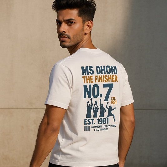 Indian male model wearing an oversized white MSD t-shirt with number 7, gold crown, and “The King of Calm” printed on the front – Dhoni-inspired casual wear for men.