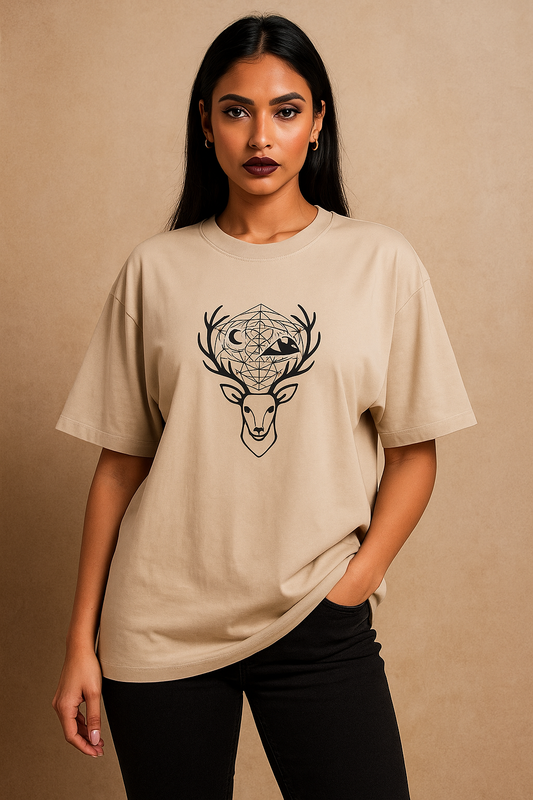 Oversized unisex t-shirt featuring a minimalist deer head with sacred geometry antlers, moon and mountain silhouettes, and a full-back design of a stag on a cliff with a glowing moon and forest tree hem – premium 240 GSM cotton, made in India.